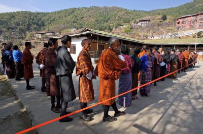 Bhutanese citizens queue to cast their vote at a polling station in Zulukha, near Thimphu, on Monday.