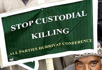 An activist holds a placard to mark the World Human Rights Day in Srinagar