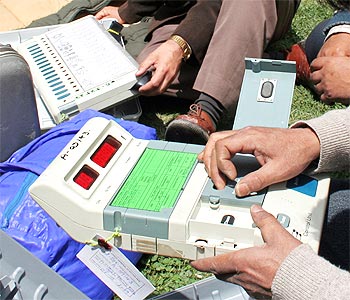 Voting officials checking the EVMs before dispatching them to polling stations