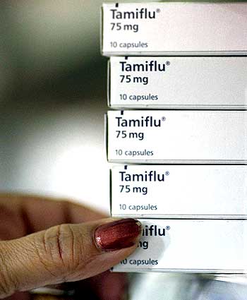 A pharmacist places boxes of Tamiflu on a shelf in Sydney