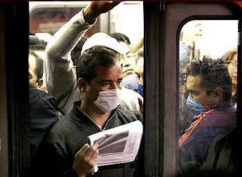Passengers wearing protective masks ride on Mexico's city subway