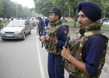 Police stand guard on the eve of India's Independence Day celebrations in Chandigarh