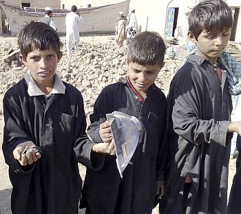Boys show off broken pieces of suspected US missiles in the Janikhel tribal area in Bannu district