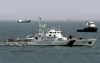 A coast guard vessel takes part in a training exercise conducted under the national oil spill disaster contingency plan at the Gulf of Kutch