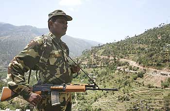 A paramilitary soldier stands guard on the Jammu-Srinagar highway