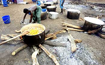 A Tamil man cooks food at the Manik Farm refugee camp.