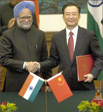 Prime Minister Manmohan Singh and Chinese Premier Wen Jiabao shake hands in Beijing