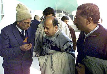 Indian negotiators hold a conversation at the Kandahar airport