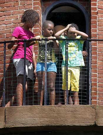 Malia (Left) and Sasha (Centre) Obama step out onto the balcony of Gay Head Lighthouse with an unidentified friend