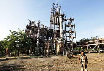 A security guard walks in front of the Union Carbide plant in Bhopal, which in December 1984 developed a toxic gas leak resulting in the death of thousands of people