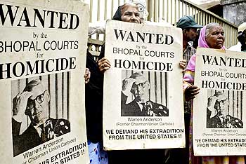 Victims hold wanted poster of former Union Carbide chairman Warren Anderson during a protest outside a court in Bhopal