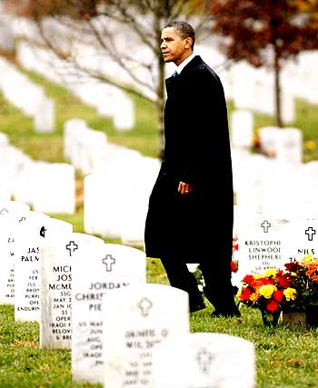 US President Barack Obama walks among the graves of soldiers killed in Iraq and Afghanistan, at the Arlington National Cemetery in Virginia on Veterans Day