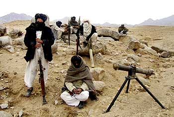 Taliban fighters pose with weapons at an undisclosed location in Afghanistan