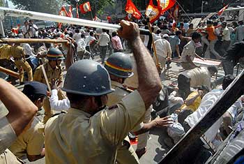 Police personnel cane demonstrators