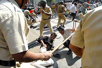 Police personnel cane violent protestors