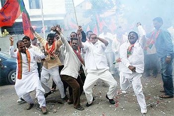 BJP workers celebrate outside the party office in Hyderabad