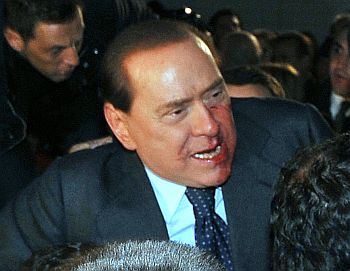 Blood covers part of the face of Italy's PM Berlusconi after he was attacked in Milan