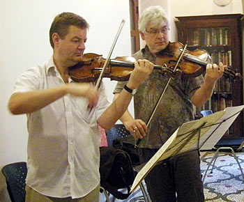 Musicians Julian Leaper and Robert Smissen practice before a performance
