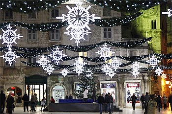 People walk past Christmas lights in the Adriatic city of Split in Croatia