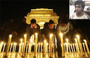 People light candles at a vigil to commemorate the victims of the 26/11 attack and (inset) Kasab