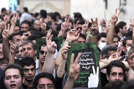 Iranian protesters show victory signs as they march near Ghoba mosque in northern Teheran June 28, 2009