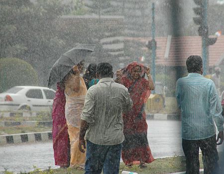 People enjoy a rare downpour in Bangalore