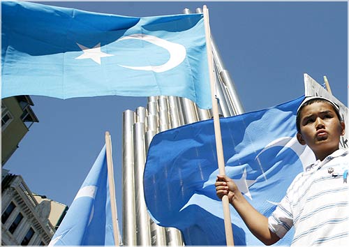 A boy holds an eastern Turkestan flag during a demonstration in Istanbul, to protest against the deadly riot in China's northwestern region of Xinjiang