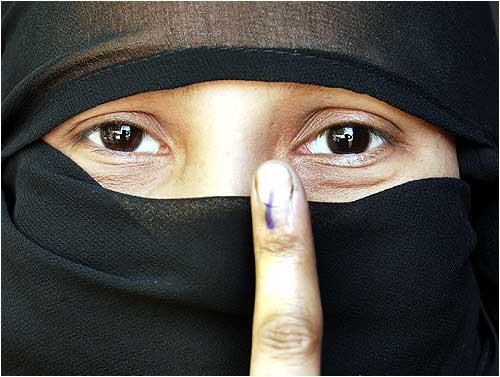 A Muslim voter shows her ink-marked finger after casting vote in Uttar Pradesh