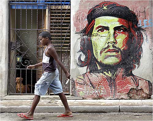 A boy walks on a street in Havana.