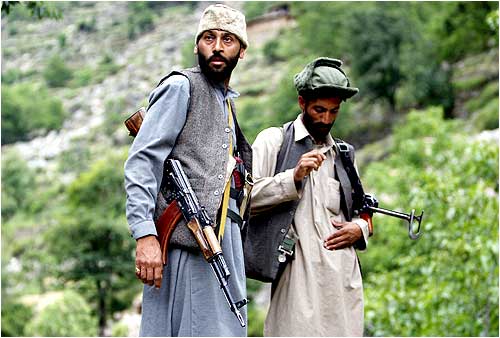 Lashkar members guarding a road pose for media in Swat