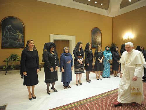 The Pope walks past the First Ladies
