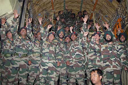 Indian army personnel gesture after their return from the first-ever joint military exercise between India and China in December 2007