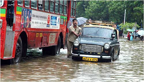 A taxi driver pushes his vehicle to safety