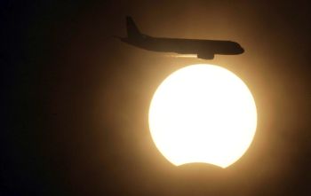 An aircraft manoeuvring during the solar eclipse in New Delhi