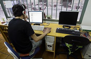 A man browses web at an Internet cafe in Madrid