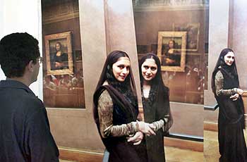 A visitor looks at a Husain collage of Madhuri Dixit at a Mumbai exhibition, December 4, 2000
