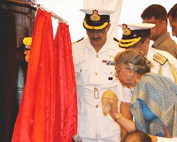 Gursharan Kaur, wife of Prime Minister Manmohan Singh breaking the auspicious coconut on the hull of the 6,000 tonne submarine, INS Arihant marking its launch