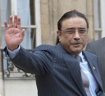President Asif Ali Zardari waves to media persons