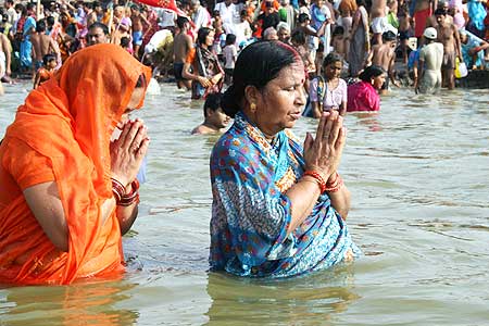 Hindu devotees pray after taking a dip in the Sangam, the confluence of three rivers, Ganges, Yamuna and Saraswati.
