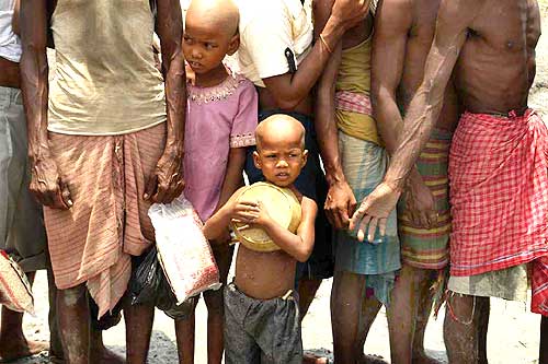 A child waits for aid in Khulna