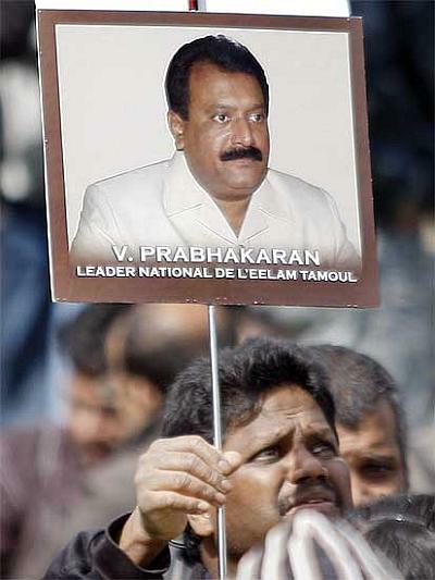 A protester waves a poster of Prabhakaran during the demonstration in support of the Tigers in Paris