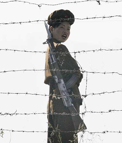 A North Korean soldier guards the banks of the Yalu River near the Chongsong county of North Korea  opposite the Chinese border town of Hekou