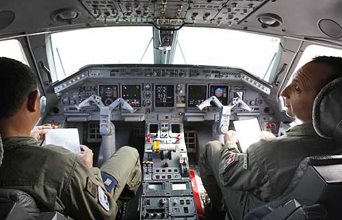 Brazilian Air Force team sit in the cabin of a R99 radar team, scoring fir clues.