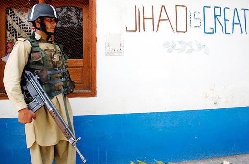 A soldier stands inside house of Muslim cleric Maulana Sufi Mohammad after it was taken over by security forces during operation in Maidan at Lower Dir district, in the Swat region