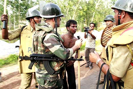 Police beat a villager suspected to be a Maoist rebel