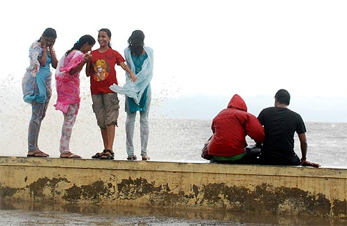 Revellers enjoy the season's  first showers at Worli sea face