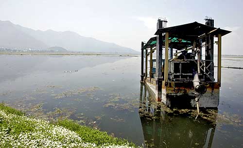 A view of a defunct weed removing machine inside the lake