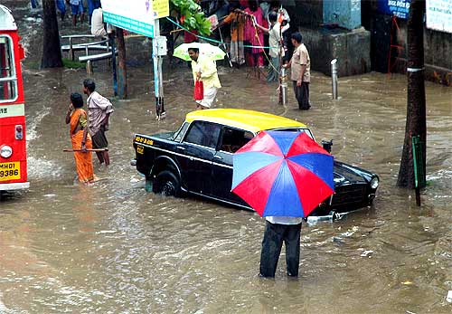 A taxi stranded at a flooded road-side