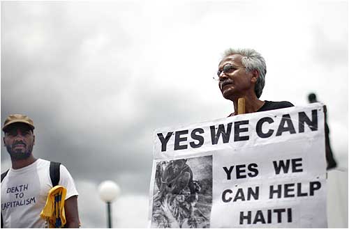 A demonstrator seeks more aid for Haiti outside the