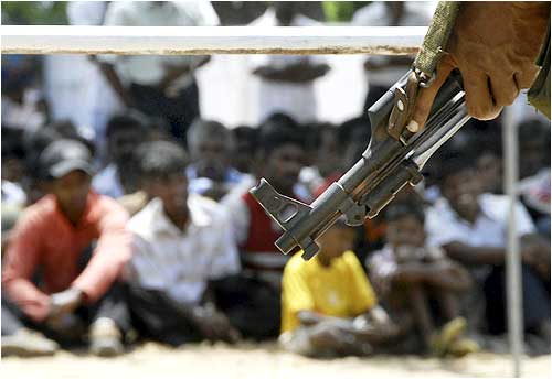 A Lankan soldier stands guard during the resettlement of refugees to their homes in Mannar, western Sri Lanka